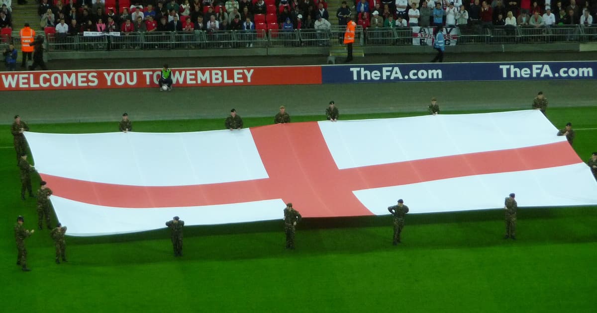 Giant St George's Cross England flag unfurled on the pitch at Wembley Stadium before an England match