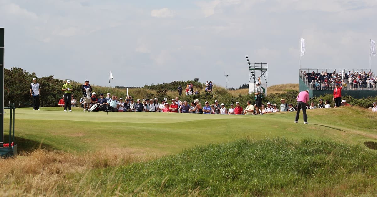 The 14th green at Royal Birkdale surrounded by spectators and a grandstand during a championship