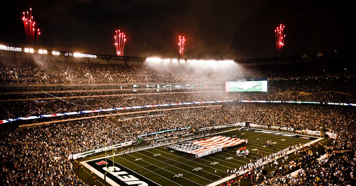 MetLife Stadium packed at night with fireworks over the stands — venue of the 2026 World Cup final